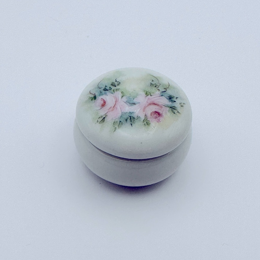 Tiny vintage porcelain trinket dish with roses on outside and inside